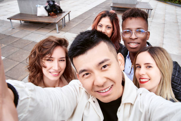 istock Diverse friends taking selfie together 1396951570