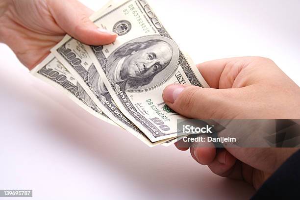 Three One Hundred Dollar Bills Exchanging Hands Stock Photo - Download Image Now - Banking, Cash Flow, Commercial Activity