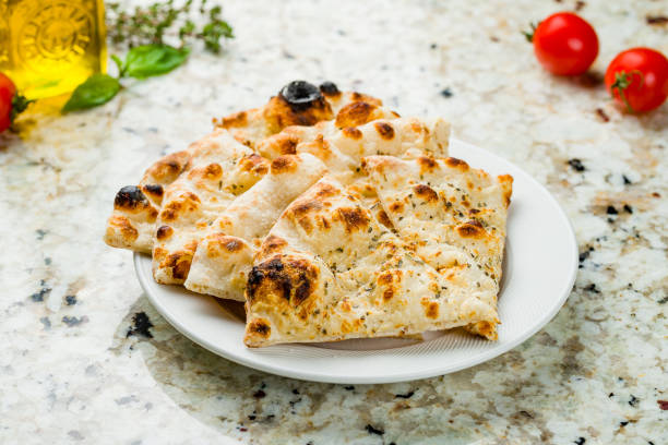 istock Focaccia with rosemary on a white plate on marble table 1396959380