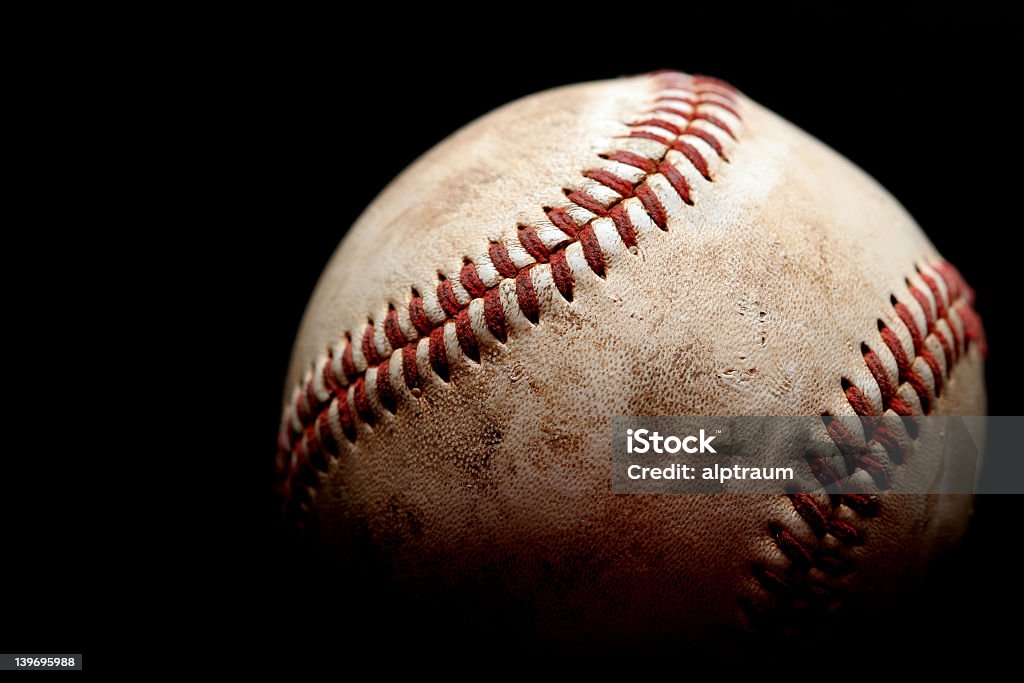 A dirty, used baseball with a black background used baseball macro over black, shallow depth of field Baseball - Ball Stock Photo