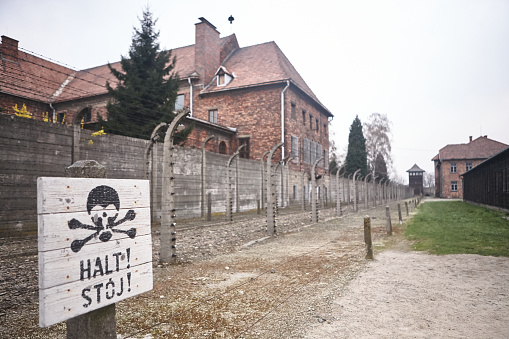 Oswiecim, Poland - March 31, 2014 : View of electric fence with barbed wire  in the former Nazi concentration camp Auschwitz-Birkenau