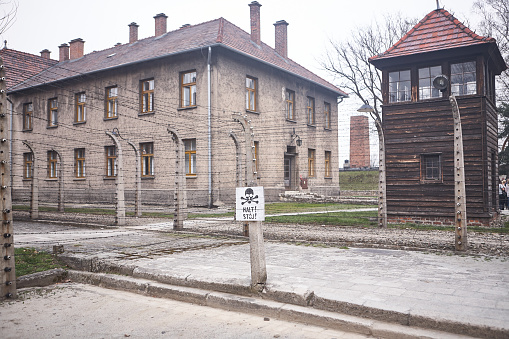 Oswiecim, Poland - March 31, 2014 : View of electric fence with barbed wire in the former Nazi concentration camp Auschwitz-Birkenau