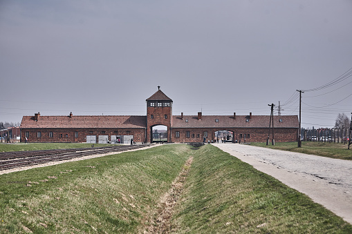 Oswiecim, Poland - March 31, 2014 : View from railway tracks onto the entrance portal of the former concentration camp Auschwitz-Birkenau