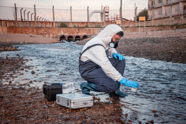 istock Scientist wearing safety uniform and glove under working water analysis and water quality by get waste water to check case in laboratory is environment pollution problem concept. 1396965576
