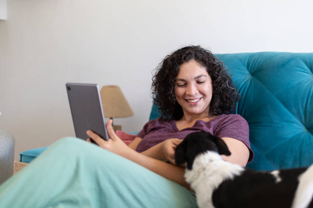istock woman working with tablet at home with pet 1396965645