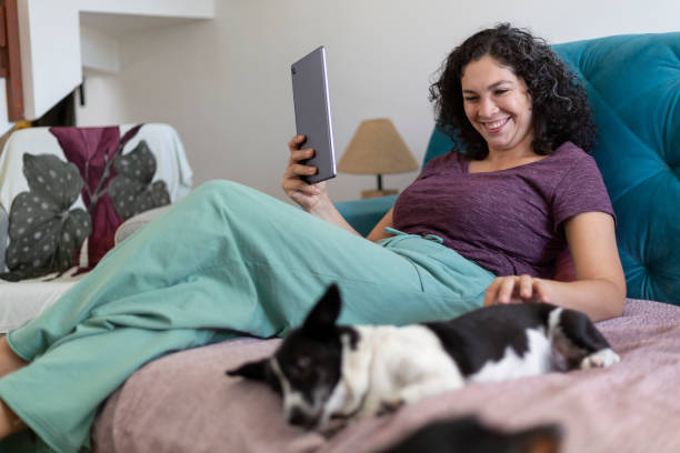 istock woman working with tablet at home with pet 1396965654