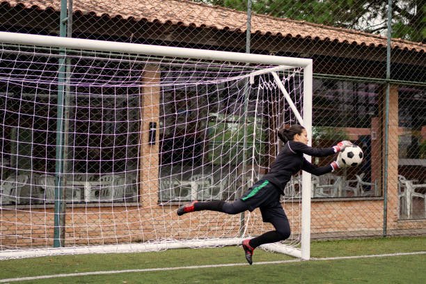 istock Female goalkeeper Catching the ball 1396967395
