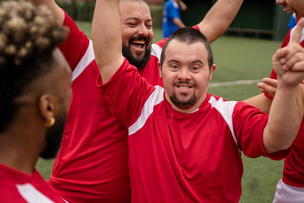 istock Soccer player with Down Syndrome celebrating scoring goal during friendly game 1396967646