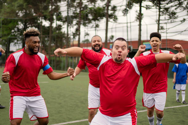 istock Soccer player with Down Syndrome celebrating scoring goal during friendly game 1396967650