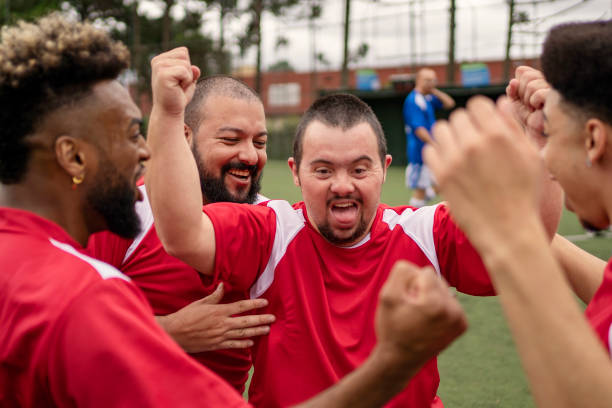 istock Soccer player with Down Syndrome celebrating scoring goal during friendly game 1396967670