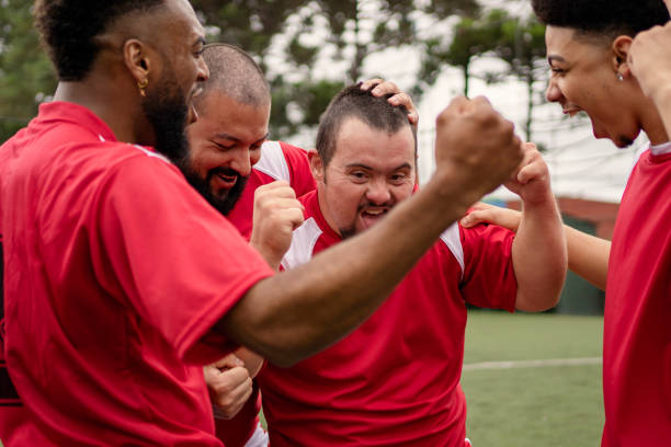 istock Soccer player with Down Syndrome celebrating scoring goal during friendly game 1396967671