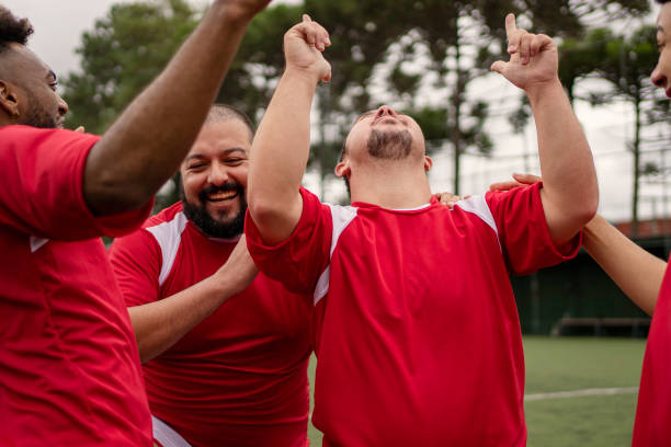 istock Soccer player with Down Syndrome celebrating scoring goal during friendly game 1396967680