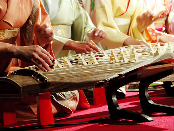 Koto band Close up of women hands wearing kimono and playing traditional Japanese musical instrument-koto traditional musician stock pictures, royalty-free photos & images