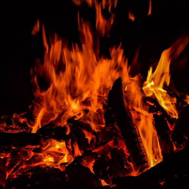 istock Fire flames on black background, Blaze fire flame texture background, Beautifully, the fire is burning, Fire flames with wood and cow dung bonfire 1396968844
