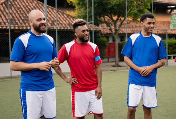 istock Group of soccer player friends talking before the game 1396968940