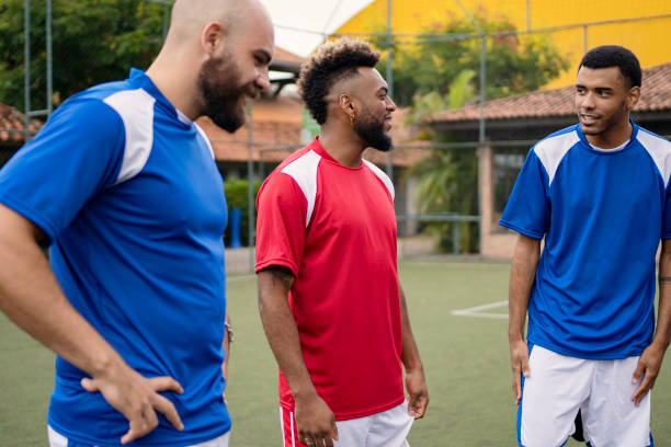 istock Group of soccer player friends talking before the game 1396968947