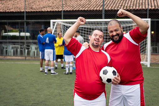 Portrait of soccer players friends. Man with Down Syndrome , social inclusion.
