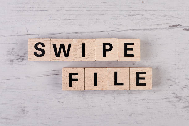 istock wooden blocks building the word SWIPE FILE 1396973424