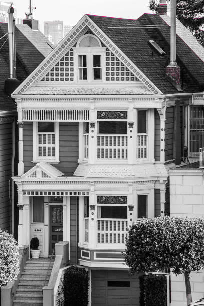 San Francisco residential house architecture with clear blue sky, featuring the upper floors of a row of Victorian houses
