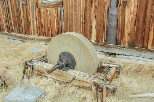 A sharpening stone sits abandoned in Bodie, California.  This abandoned city has now become a State Park. Relics such as this sharpening stone can be seen amongst the many buildings. Many visitors come near go to this star park every year.