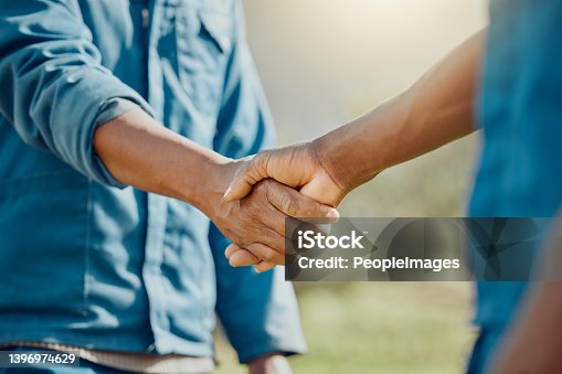 istock Cropped shot of two unrecognisable farmers standing together and shaking hands 1396974629