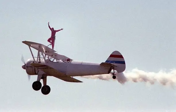 Photo of wingwalker at a barnstorming air show.  Photo has some grain due to cropping and 200 speed 35MM print film used.