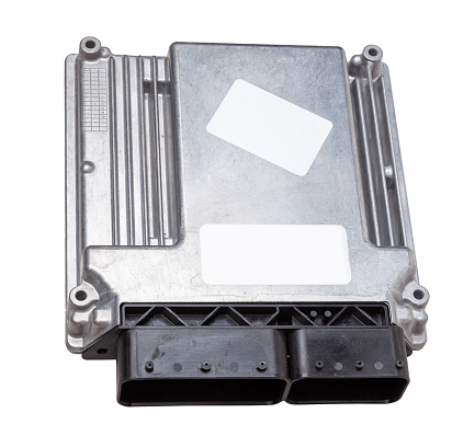 Metallic car engine control unit with plastic elements on a white isolated background is connecting center of various subsystems, units and assemblies. Monitoring the state of the moment. Spare part