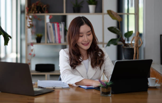 istock Business asian woman using laptop computer at her office 1396978818