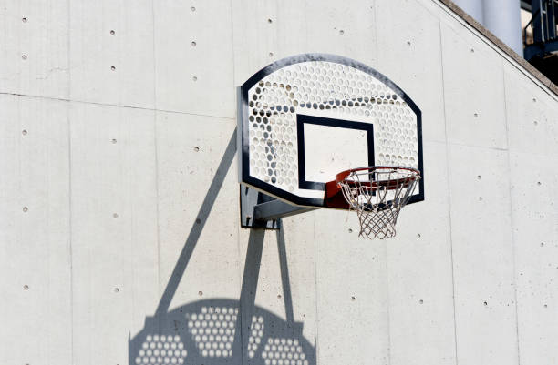istock Basketball hoop on a white concrete wall 1396979045