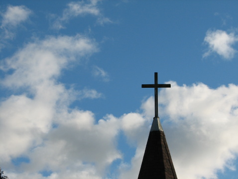 upward shot of a cross against the sky.
