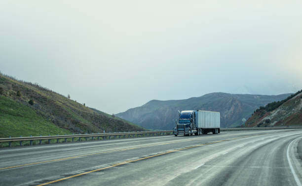 istock Blue and white semi-truck driving in Utah mountain range 1396981017