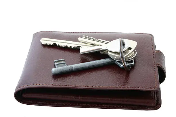 Photo of bunch of keys on brown leather wallet