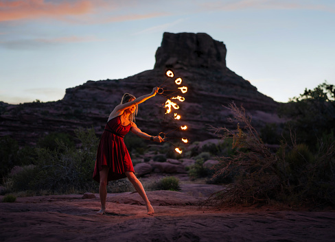 Young woman doing a fire dance performance