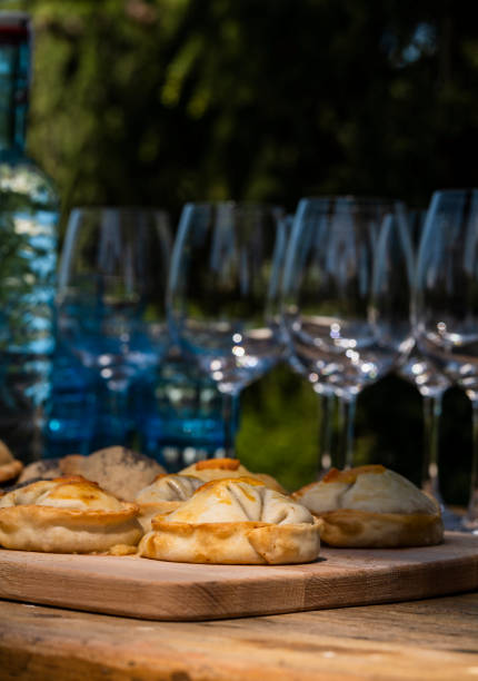 istock Argentinian stuffed pastries on table with glass bottles and cups 1396982593