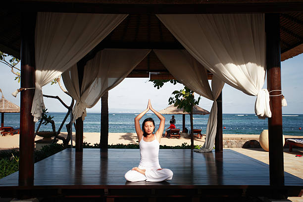 istock Asian Woman Meditating by the Beach 139698425