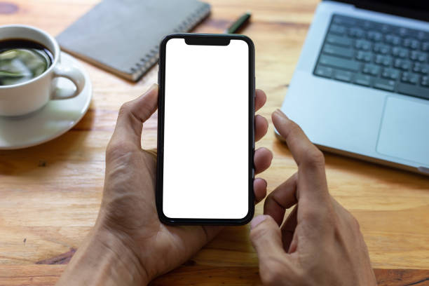 istock man hand using smartphone In the office Screen blank with clipping path ,Top view mockup image of male holding mobile phone with empty white screen 1396985354