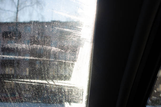 istock Frost pattern on glass of car on blue sky background 1396986284