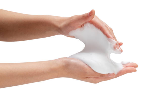 Female hand with soap bubbles on white background.