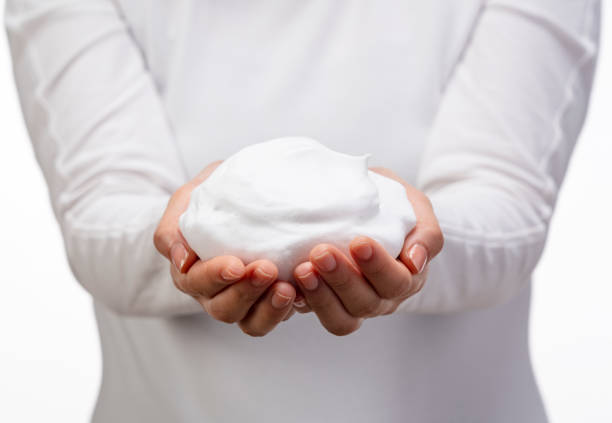 istock Female holding soap bubbles on white background. 1396989052