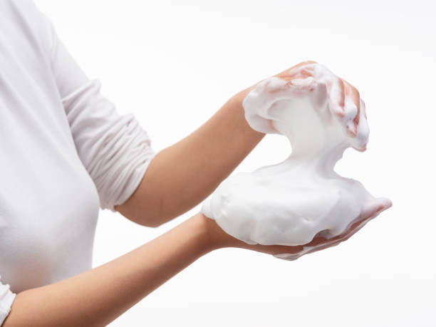 istock Female holding soap bubbles on white background. 1396989068