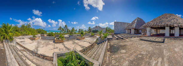istock Picture of a destroyed, overgrown and left to itself hotel complex on a beach 1396991382