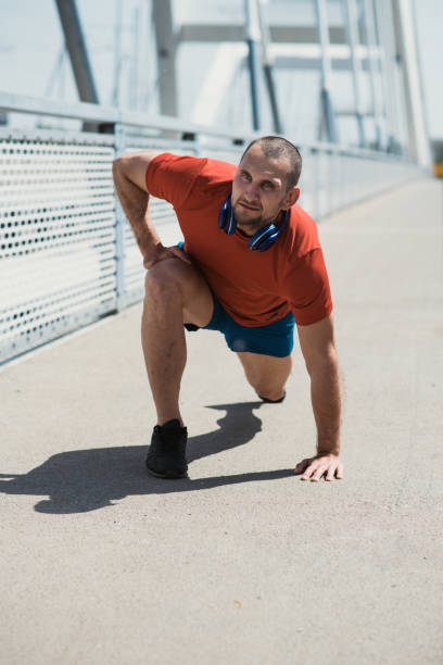 istock Hand amputee Paralympic athlete doing stretch exercises on a bridge 1396995307