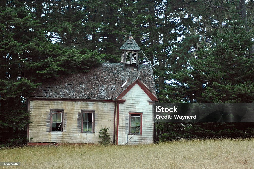 Delapitated Schoolhouse An old, small, abandoned and delapitated schoolhouse in a meadow. Abandoned Stock Photo
