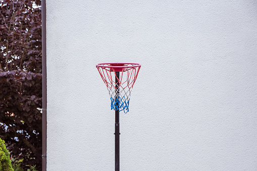 a little basketball hoop in front of a house wall