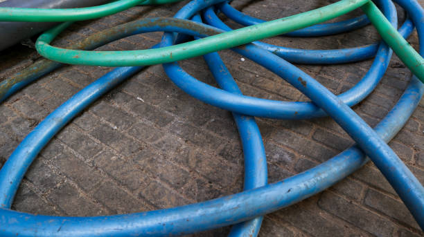 istock blue and green hoses scattered in the yard 1396997269