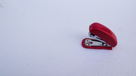 red stapler on a white background.