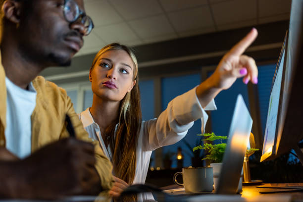 istock Serious Female manager explaining to a male coworker something 1396998093