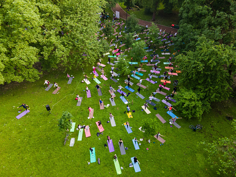 overhead view of people do yoga at city public park