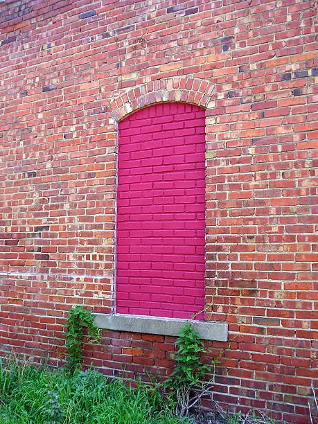 Digital image of an old doorway that has been covered with bricks.