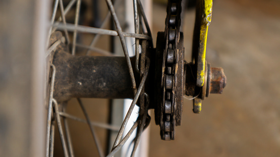 Bike service, pedal maintenance. Photo of Bike close up on gear wheel, pedal and wheel  in the sunny garage or workshop.